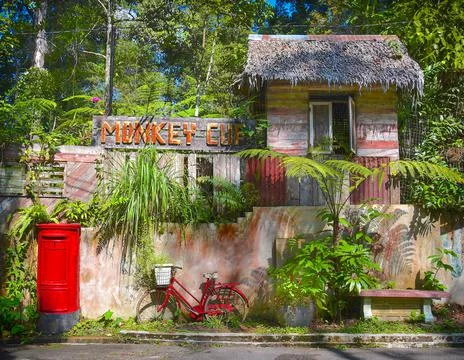 Red pillar box and rustic bike. Stock Photos