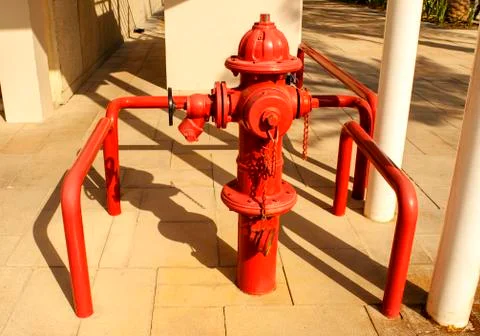 Red pillar-type fire hydrant for emergency fire access in a street. Fotos de archivo