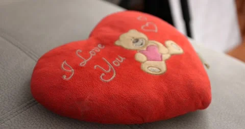 Red Pillow heart shaped with a bear and I love you text on a couch valentines Stock Footage 150201306