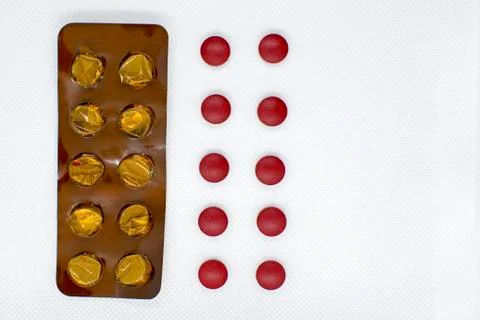 Red pills and an empty stack of pills on a white background, concept. liver t Stock Photos