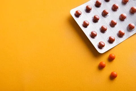 Red pills with packaging Stock Photos