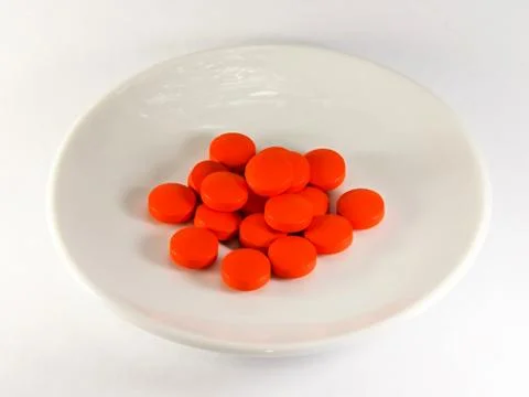 Red pills on a plate Stock Photos