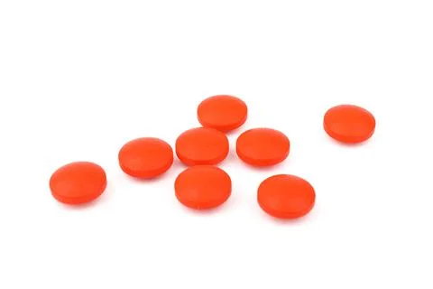 Red pills on a white background, isolated. Pharmacy. Treatment. Stock Photos