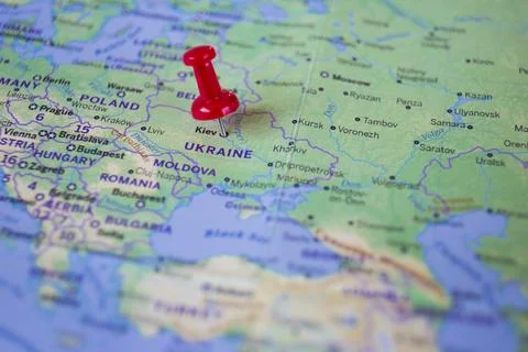 A red pin embroidered on the world map of Ukraine, the city of Kiev. Stock Photos