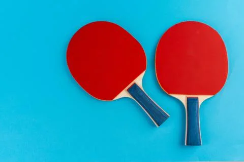 Red ping pong racket on a blue background Stock Photos