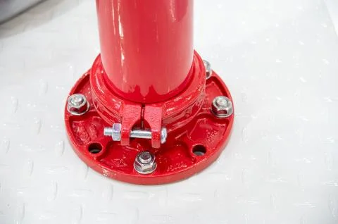 A red pipe with a bolt on it Stock Photos