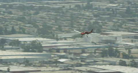 Red plane flying over suburbs, helicopter aerial, drone footage Video stock 106351810