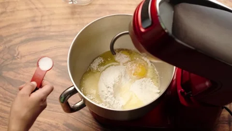 Red planetary mixer, adding a teaspoon of salt with a red measuring spoon Stock Footage 281459862
