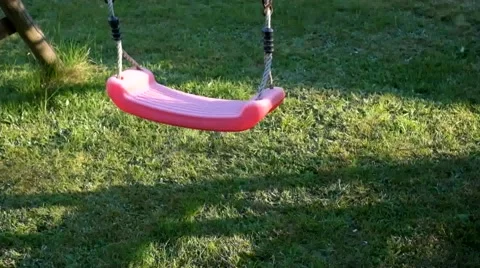 Red plastic baby swing Stock Footage 62899532