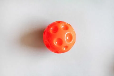 Red Plastic ball as virus on the gray background, medical concept Stock Photos