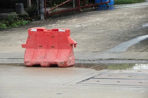 Red plastic barriers set up along the roadside Foto stock