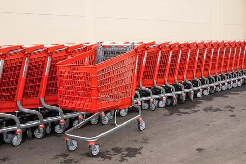 Red plastic baskets-carts for goods Foto stock