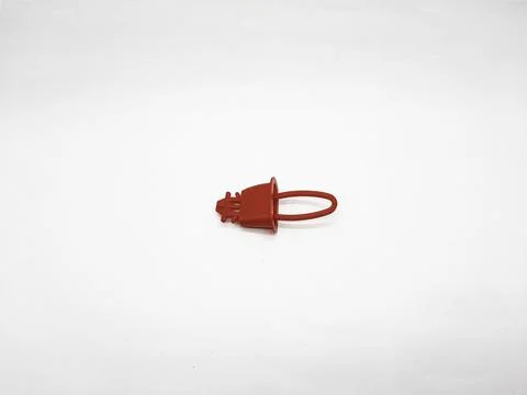 Red plastic cap on a white background used for protection and sealing Stock Photos