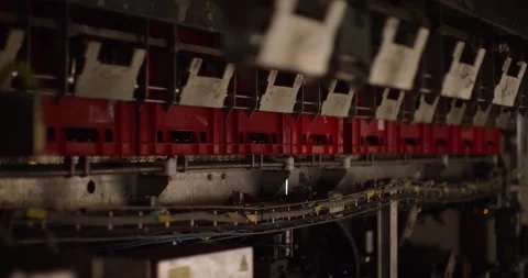 Red plastic crates move through an automated conveyor system inside an Stock Footage 340003107