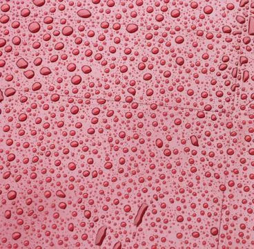 Red plastic during a rain. background Stock Photos
