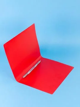 Red plastic folder  for documents isolated on blue  background Foto stock