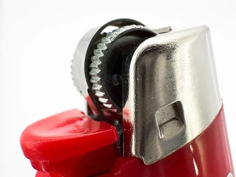 Red plastic lighter on a white background side view of the lighter in macro side Stock Photos