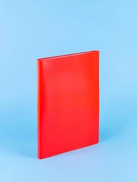 Red plastic office folder on blue background. Office Folder Template Stock Photos
