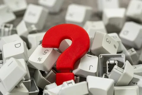 Red plastic question mark in the pile of computer keyboard keys 스톡 사진
