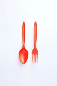 A red plastic spoon and fork Stock Photos