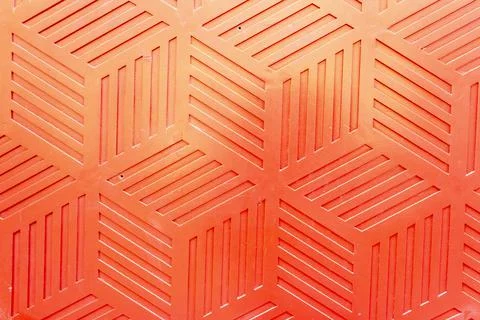 Red plastic surface with repetitive geometric shapes. Seamless geometrical Stock Photos