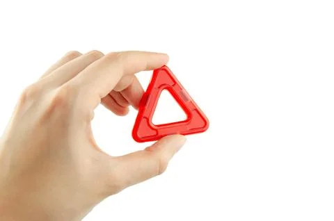 Red plastic triangle from transparent magnet constructor kit (puzzle builder) Stock Photos