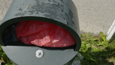 A red plastic waste inside the garbage bin in Estonia 스톡 동영상 205473616