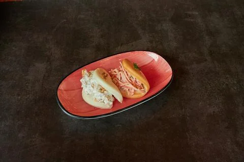 A red plate with two different types of food on it Stock Photos