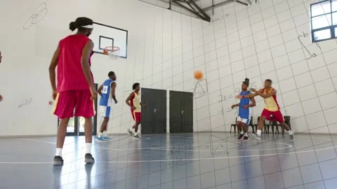 Red player dribbling, passing to wing, shooting basketball to score while math Stock Footage 333446164
