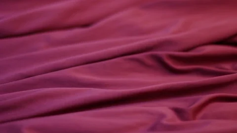 Red pleated fabric moves on the surface close-up, fashionable background Stock Footage 122189969