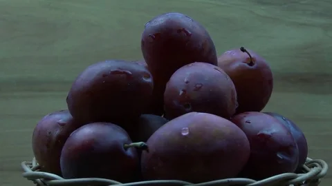 Red plums on the spinning plate Stock Footage 80107888
