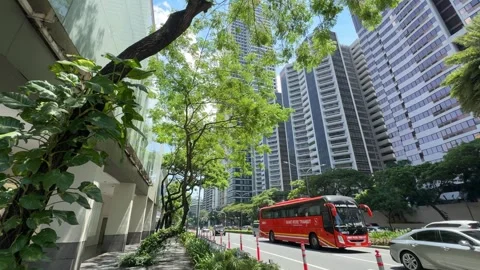 Red point to point P2P transit bus driving along Ayala Avenue Makati 4k Stock Footage 337443365