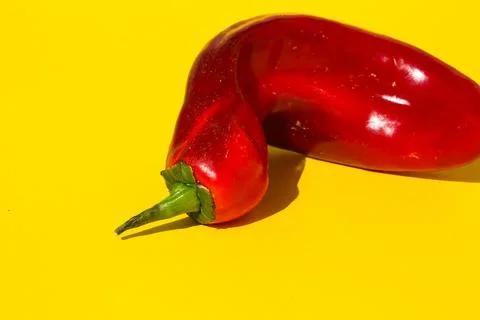 Red pointed pepper on a yellow background, art Stock Photos