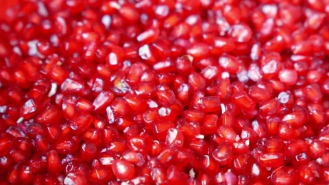 Red pomegranate grains as background rotating in slow motion. Top view. Stock Footage 309059385