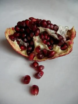 Red pomegranate on a light background Stock Photos