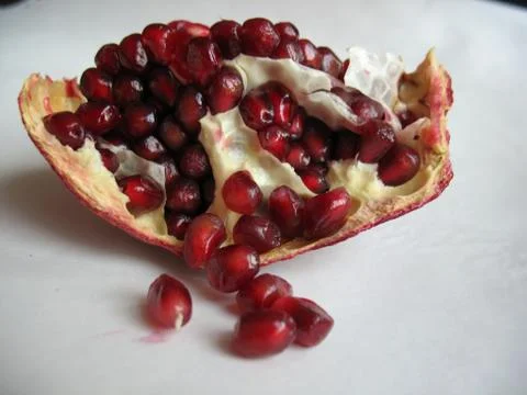 Red pomegranate on a light background Stock Photos