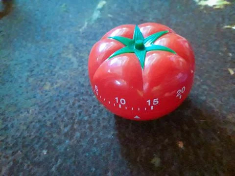 Red Pomodoro timer to help in concentration, improve productivity. Stock Photos