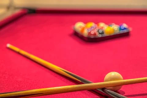 Red pool table with cue sticks billiard balls Stock Photos