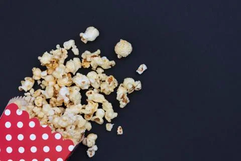 Red popcorn box on black background with copy space Stock Photos