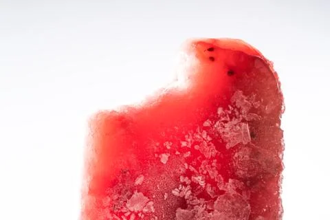 Red popsicle with icesicles with a bite on a white background. Foto stock