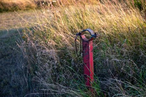 Red post on a field for a barrier Stock Photos