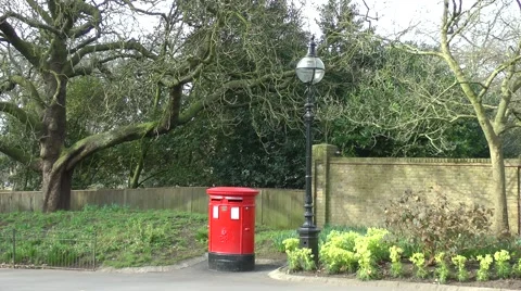 Red post mail box old lamp spring sunshine Stock Footage 48401561