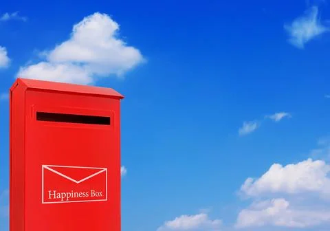 Red postbox representing happiness concept with copy space on sky background Stock Photos