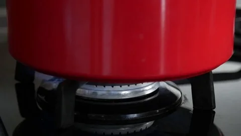 Red Pot on the cooker Stock Footage 73866755
