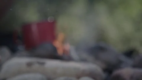 Red pot on small camp fire Stockbeeldmateriaal 76739607