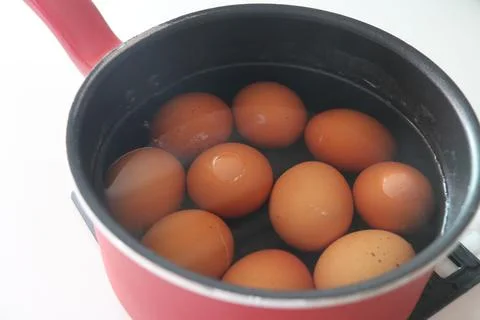 Red Pot with Steaming Boiled Eggs Inside Stock Photos