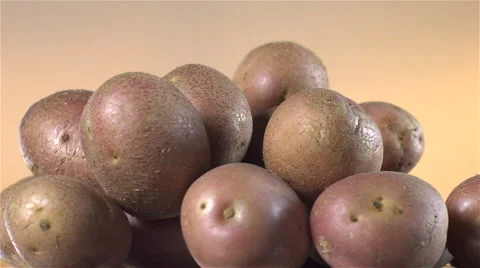 Red Potatoes isolated rotating on brown background. Stock Footage 63344746