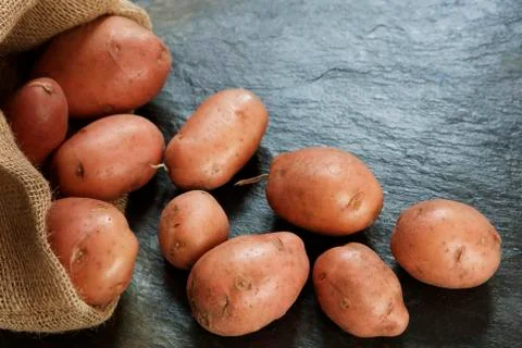 Red Potatoes on slate table Stock Photos