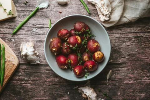 Red Potatoes with Thyme on a Rustic Table Stock Photos