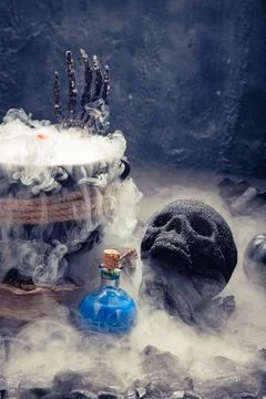 Red potion bottle sits in white mist. Stock Photos